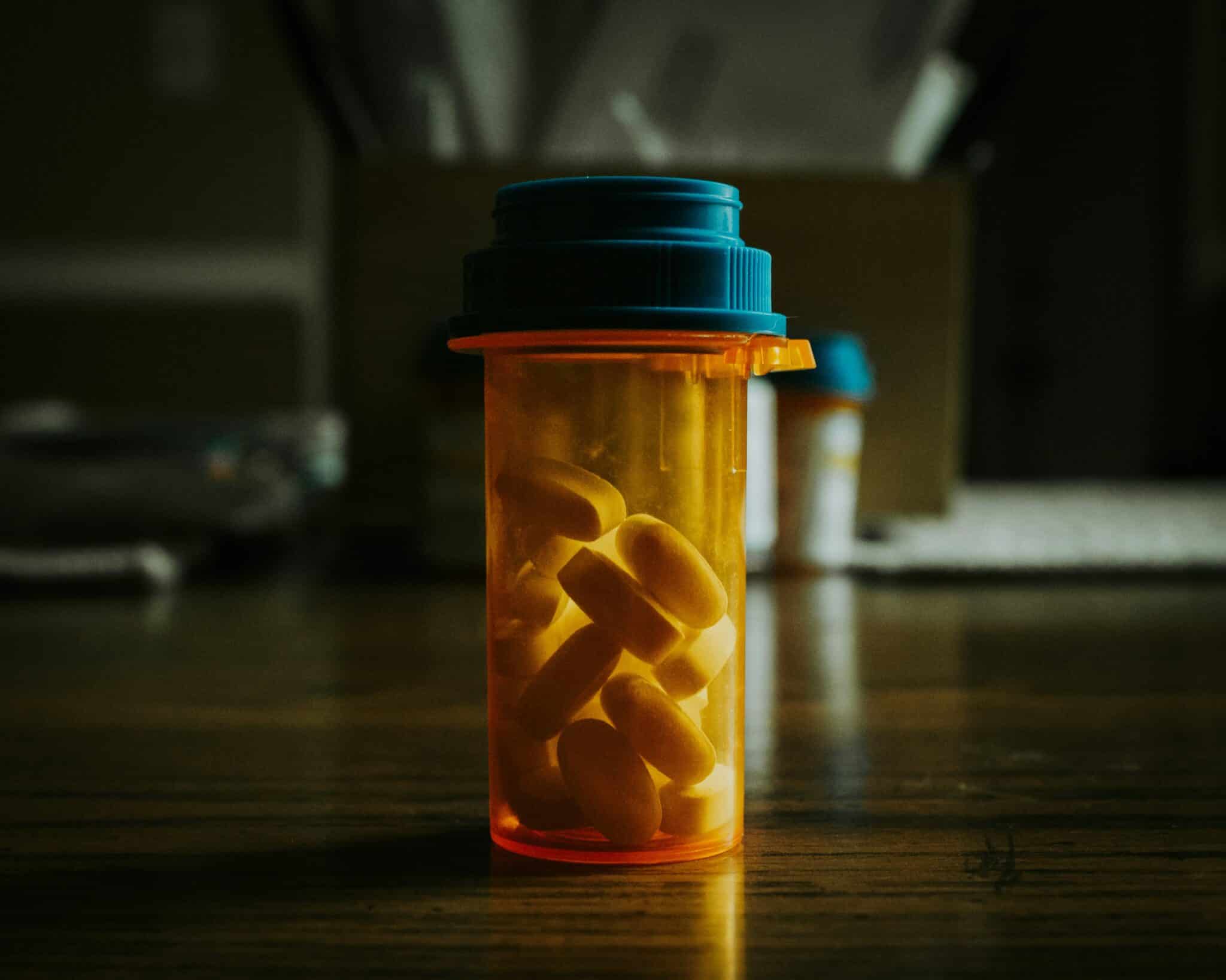 An amber bottle filled with pills