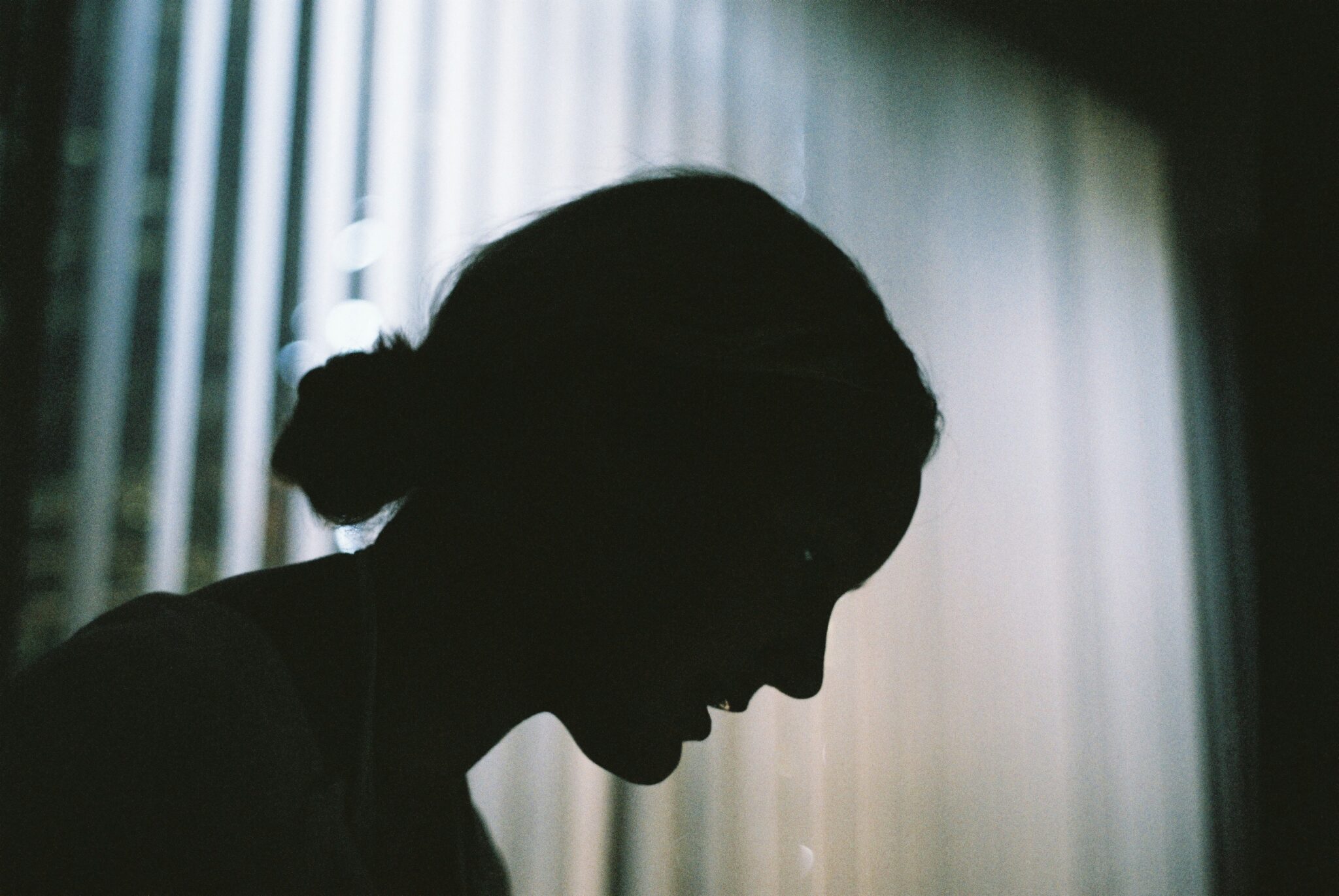 Woman in the dark having a migraine
