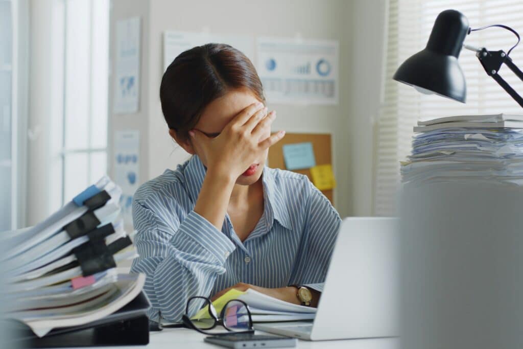 Woman having a migraine in the office